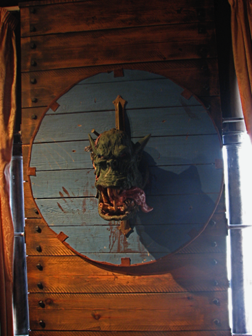 An orc’s head attached to a shield overlooks the swilling in Bugman’s. A shame about the photo